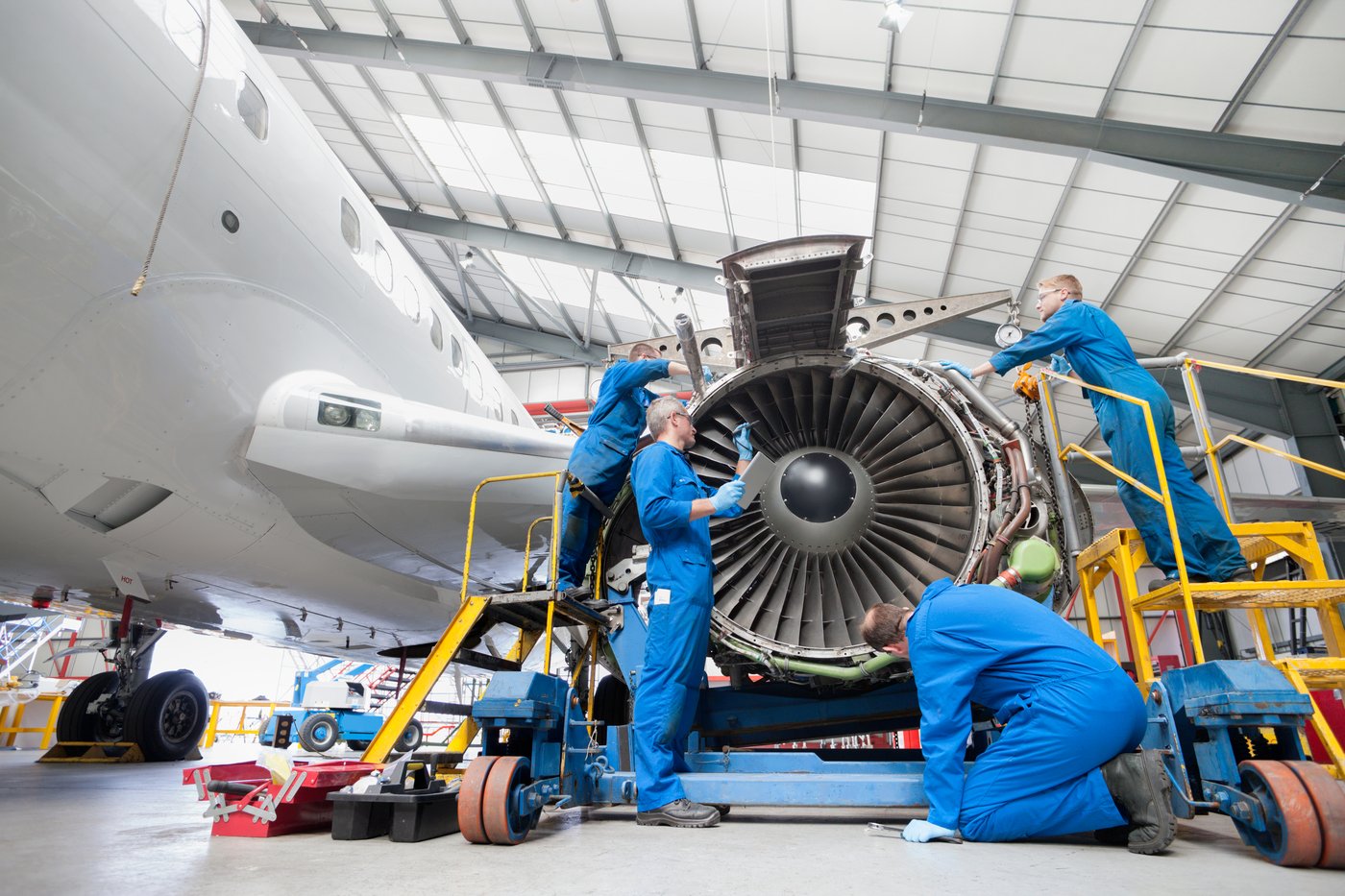 Mechanics servicing a jet engine
