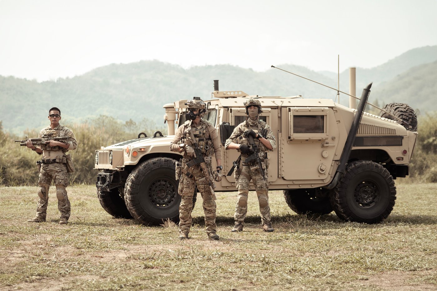 Personnel beside a tactical vehicle