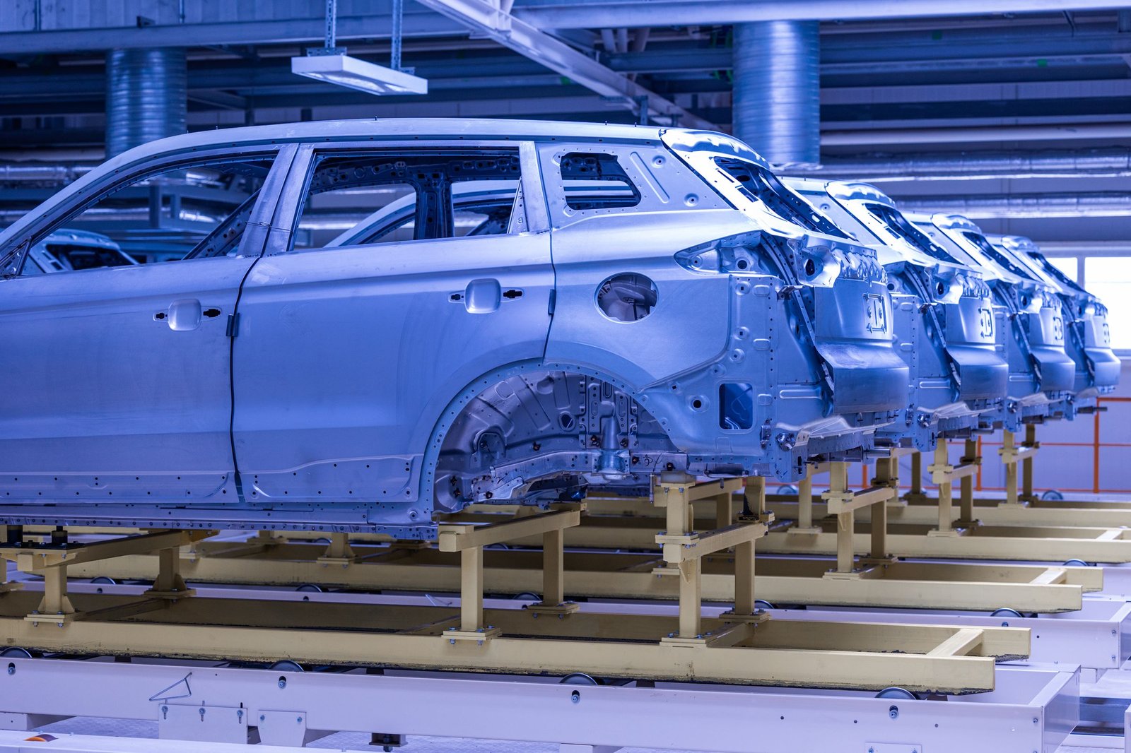 Row of car bodies under blue light