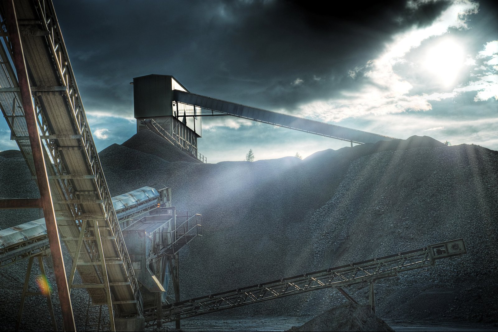 Conveyors feeding a screening tower above stockpiles