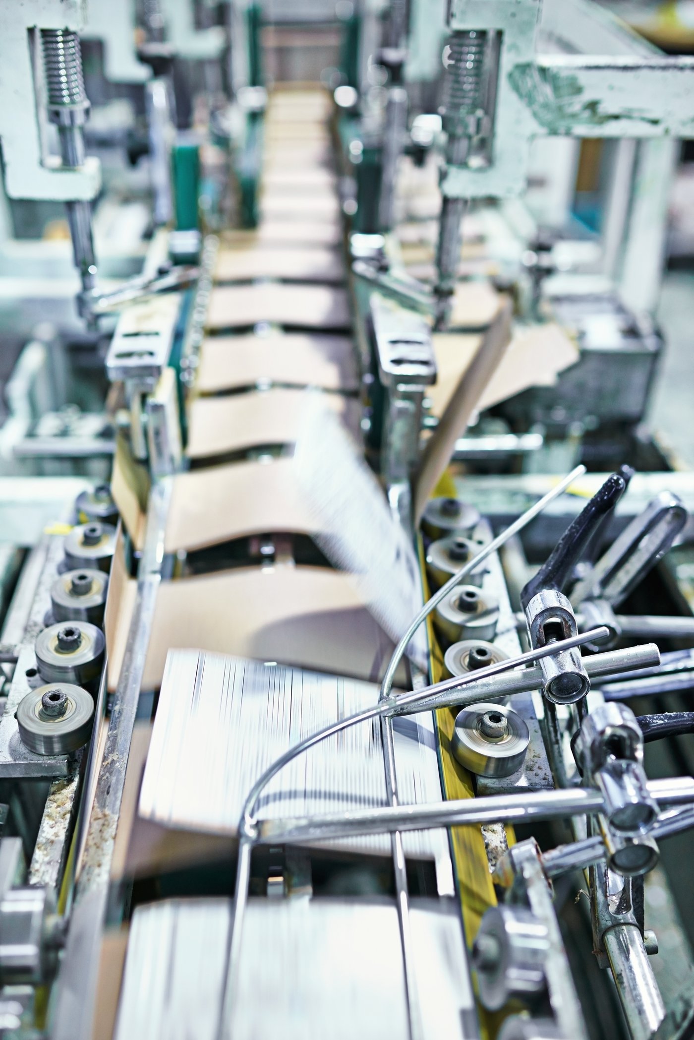 Carton blanks moving at speed through a folder-gluer