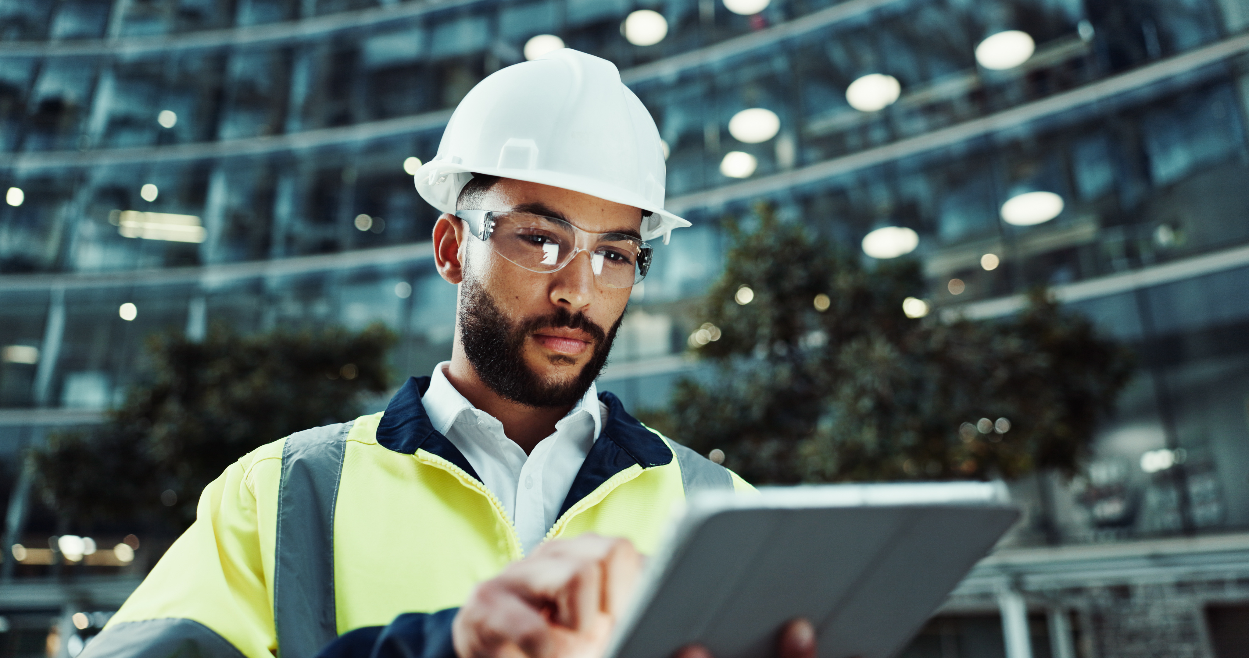 Engineer reviewing operational data on a tablet on a plant site